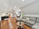 Spacious bonus room with hardwood floors, a comfortable sectional, and a dining table at 3519 Weddington Oaks Dr, Matthews, NC 28104