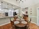 Breakfast nook and open-plan kitchen with hardwood floors and modern lighting at 3519 Weddington Oaks Dr, Matthews, NC 28104