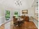 Sunlit breakfast nook with wood table and chairs, and two large windows with views at 3519 Weddington Oaks Dr, Matthews, NC 28104