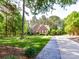 Charming brick home with lush landscaping, mature trees and a beautiful stone walkway at 3519 Weddington Oaks Dr, Matthews, NC 28104