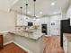 Bright kitchen features white cabinets, granite countertops, and stainless steel appliances at 3519 Weddington Oaks Dr, Matthews, NC 28104