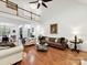 Bright open living room with fireplace, hardwood floors and a view of the dining area at 3519 Weddington Oaks Dr, Matthews, NC 28104