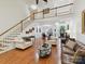 Bright, open living room with fireplace, stairs, and large windows at 3519 Weddington Oaks Dr, Matthews, NC 28104