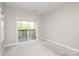 Neutral bedroom features a sliding glass door to a private balcony at 3937 Arbor Ln # H, Charlotte, NC 28209
