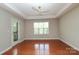 Spacious bedroom with hardwood flooring, balcony access, ceiling fan, and lots of natural light at 3937 Arbor Ln # H, Charlotte, NC 28209