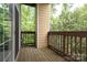 Cozy outdoor deck with wood railings, providing a view of surrounding trees and greenery at 3937 Arbor Ln # H, Charlotte, NC 28209