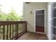 Spacious deck with wood railings offering a peek into a room with a ceiling fan at 3937 Arbor Ln # H, Charlotte, NC 28209