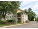 Inviting exterior view of a three-story condo with lush landscaping and a charming, private balcony at 3937 Arbor Ln # H, Charlotte, NC 28209