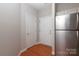 Bright foyer with hardwood floors, features stainless steel refrigerator and convenient entry access at 3937 Arbor Ln # H, Charlotte, NC 28209