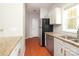 Kitchen boasts stainless steel appliances, granite counters, and light wood flooring at 3937 Arbor Ln # H, Charlotte, NC 28209