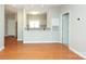 Modern living room showcases hardwood floors, connecting the kitchen through the open bar seating area at 3937 Arbor Ln # H, Charlotte, NC 28209