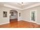 Inviting living room featuring hardwood floors, open archways, and balcony access, perfect for entertaining at 3937 Arbor Ln # H, Charlotte, NC 28209