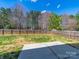 Large, fenced backyard featuring a concrete patio, perfect for entertaining and outdoor activities at 4018 Larkhaven Village Dr, Charlotte, NC 28215