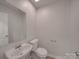 Bathroom features a sink, mirror, and toilet at 4018 Larkhaven Village Dr, Charlotte, NC 28215