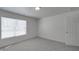 Bedroom featuring a bright window with blinds and a closet door at 4018 Larkhaven Village Dr, Charlotte, NC 28215