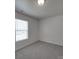 Well-lit bedroom with a window overlooking the front yard and carpeted floors at 4018 Larkhaven Village Dr, Charlotte, NC 28215