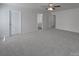 Spacious carpeted bedroom with ceiling fan and multiple entrances at 4018 Larkhaven Village Dr, Charlotte, NC 28215