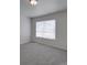 Bedroom featuring a window with blinds and neutral carpeting at 4018 Larkhaven Village Dr, Charlotte, NC 28215