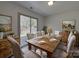 A dining room featuring a wooden table, six chairs, and sliding doors leading to the outdoor space at 4018 Larkhaven Village Dr, Charlotte, NC 28215