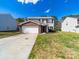 Charming two-story home featuring a brick-accented garage and a well-maintained front lawn on a sunny day at 4018 Larkhaven Village Dr, Charlotte, NC 28215