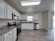 Bright kitchen features stainless steel appliances, granite countertops, and white cabinets at 4018 Larkhaven Village Dr, Charlotte, NC 28215