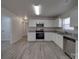 Bright kitchen features stainless steel appliances, granite countertops, and white cabinets at 4018 Larkhaven Village Dr, Charlotte, NC 28215