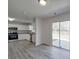 Open layout of bright kitchen with stainless steel appliances and an adjacent living area at 4018 Larkhaven Village Dr, Charlotte, NC 28215