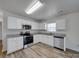 Bright kitchen features stainless steel appliances, granite countertops, and white cabinets at 4018 Larkhaven Village Dr, Charlotte, NC 28215
