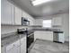 Bright kitchen features stainless steel appliances, granite countertops, and white cabinets at 4018 Larkhaven Village Dr, Charlotte, NC 28215
