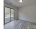 Living room with sliding door access to the backyard patio and neutral-colored walls at 4018 Larkhaven Village Dr, Charlotte, NC 28215