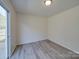Living room with sliding door access to the backyard patio and neutral-colored walls at 4018 Larkhaven Village Dr, Charlotte, NC 28215