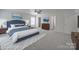 Spacious bedroom with a blue upholstered bed, ceiling fan, and neutral carpet providing a comfortable retreat at 4018 Larkhaven Village Dr, Charlotte, NC 28215