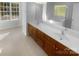 Elegant bathroom with a dual sink vanity, a large mirror, and a soaking tub at 4035 Caldwell Ridge Pkwy, Charlotte, NC 28213