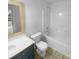 Bathroom with a tub and shower combo, and a toilet and sink with storage underneath at 4035 Caldwell Ridge Pkwy, Charlotte, NC 28213