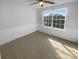 Bright bedroom featuring a large window and classic wainscoting detail along the lower walls at 4035 Caldwell Ridge Pkwy, Charlotte, NC 28213