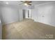 Spacious bedroom with neutral carpeting and ceiling fan, offering ample space for relaxation at 4035 Caldwell Ridge Pkwy, Charlotte, NC 28213