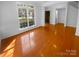 Bright living room features hardwood floors, large windows and fresh, neutral paint at 4035 Caldwell Ridge Pkwy, Charlotte, NC 28213