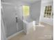 Spa-like bathroom features soaking tub, glass-enclosed shower and neutral design at 4035 Caldwell Ridge Pkwy, Charlotte, NC 28213