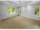 Spacious main bedroom with neutral carpet and paint, and an abundance of windows at 4035 Caldwell Ridge Pkwy, Charlotte, NC 28213