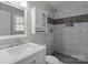 Updated bathroom features tiled shower with niche, modern vanity, and fixtures at 4050 Leafmore St, Concord, NC 28027