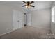 Bedroom with neutral walls, carpet, ceiling fan and a large closet at 4050 Leafmore St, Concord, NC 28027