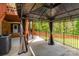 View of the covered patio with access to the lawn and featuring stylish gray-and-white curtains at 4050 Leafmore St, Concord, NC 28027