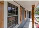 Close-up of gray house siding, wooden shutters, and stone floor on the front porch at 4050 Leafmore St, Concord, NC 28027