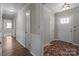 Hallway with wood flooring, wainscoting, and access to multiple rooms at 4050 Leafmore St, Concord, NC 28027