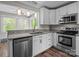Bright kitchen featuring white cabinets, stainless steel appliances, and granite countertops at 4050 Leafmore St, Concord, NC 28027