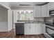 Bright kitchen featuring white cabinets, stainless steel appliances, and granite countertops at 4050 Leafmore St, Concord, NC 28027