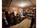 Finished basement with wood paneling, drop ceiling, and wire shelving unit filled with storage items at 406 S Caldwell Ave, Newton, NC 28658