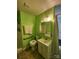 Cozy bathroom with green walls features a shower, toilet, and a vanity sink at 406 S Caldwell Ave, Newton, NC 28658