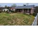 One-story brick home featuring an inviting front porch, surrounded by green lawn and partial landscaping at 406 S Caldwell Ave, Newton, NC 28658
