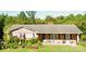 Charming, one-story brick home with a cozy porch and lush, well-maintained landscaping at 406 S Caldwell Ave, Newton, NC 28658